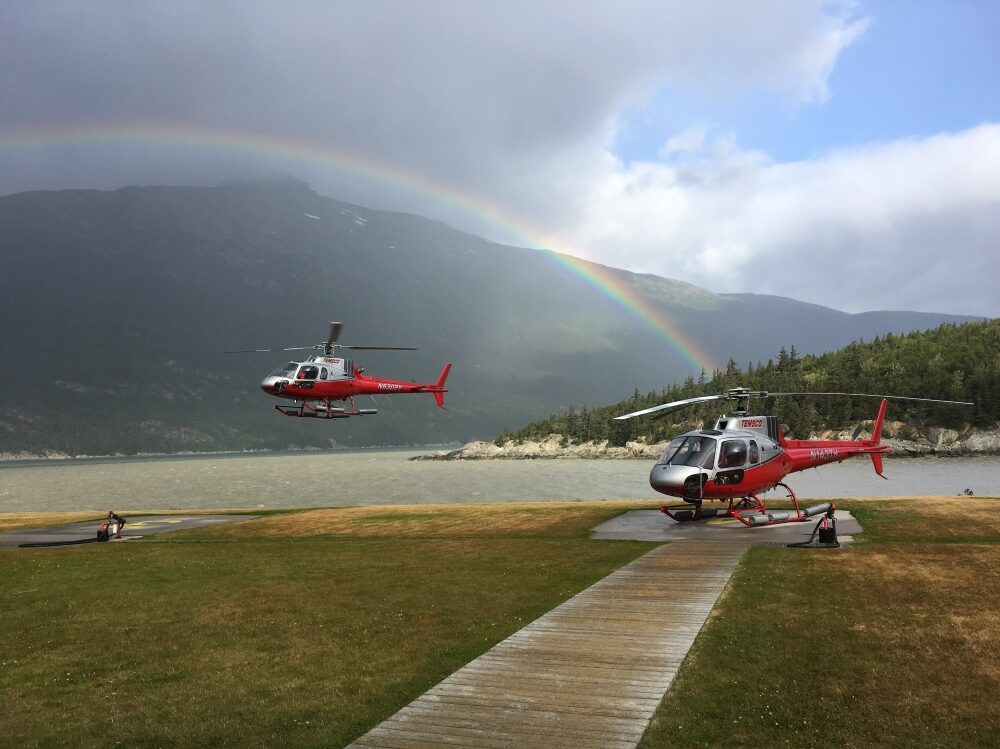 A helicopter is being worked on by someone.