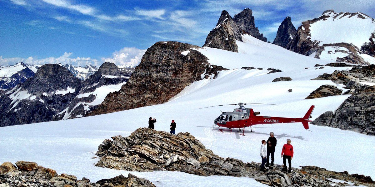 A helicopter is being worked on by someone.