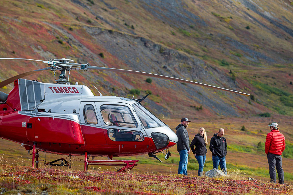 A helicopter is being worked on by someone.