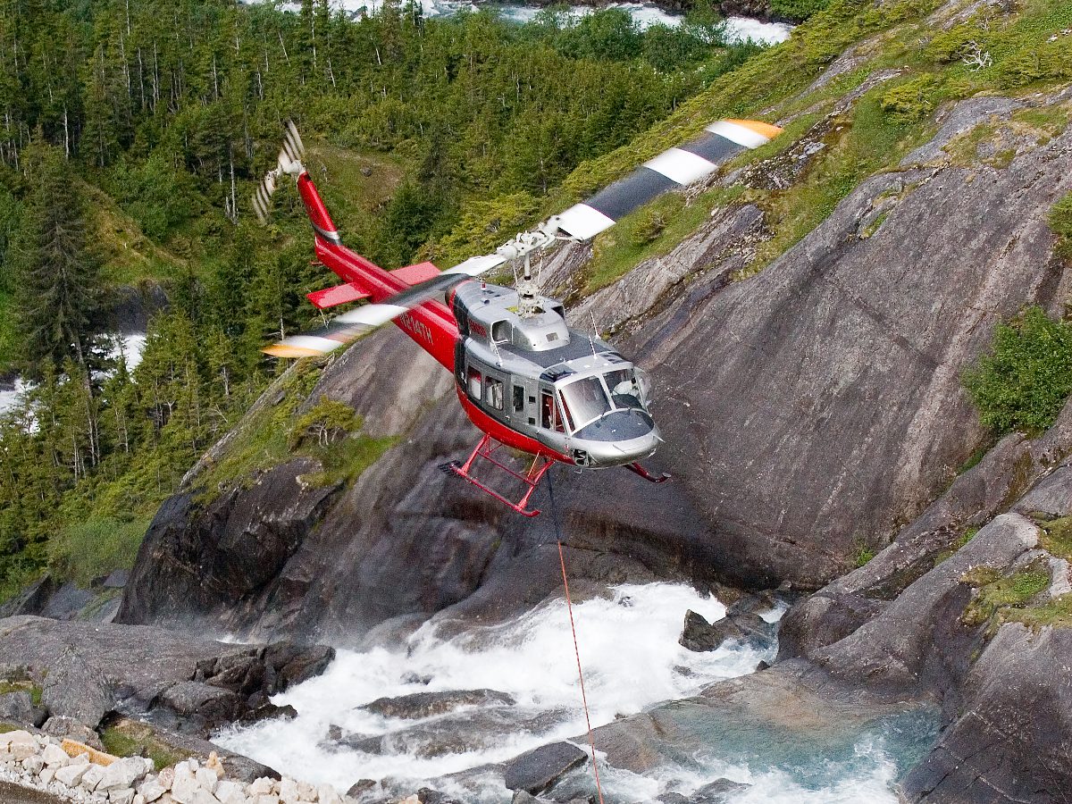 a person flying through the air on a rock