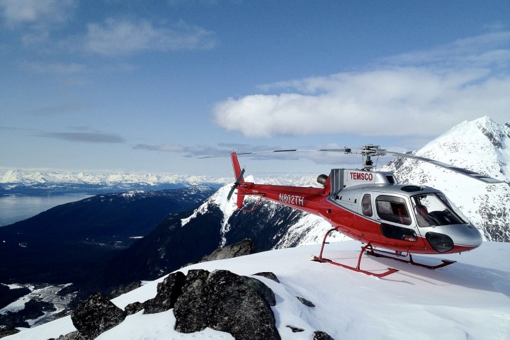 a man riding skis down a snow covered mountain
