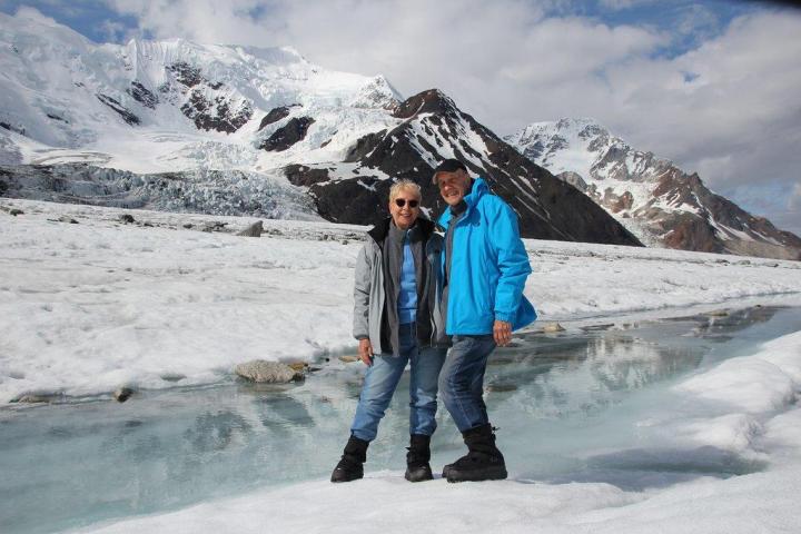 a person standing on top of a snow covered mountain