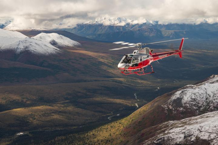 a man flying through the air on top of a mountain