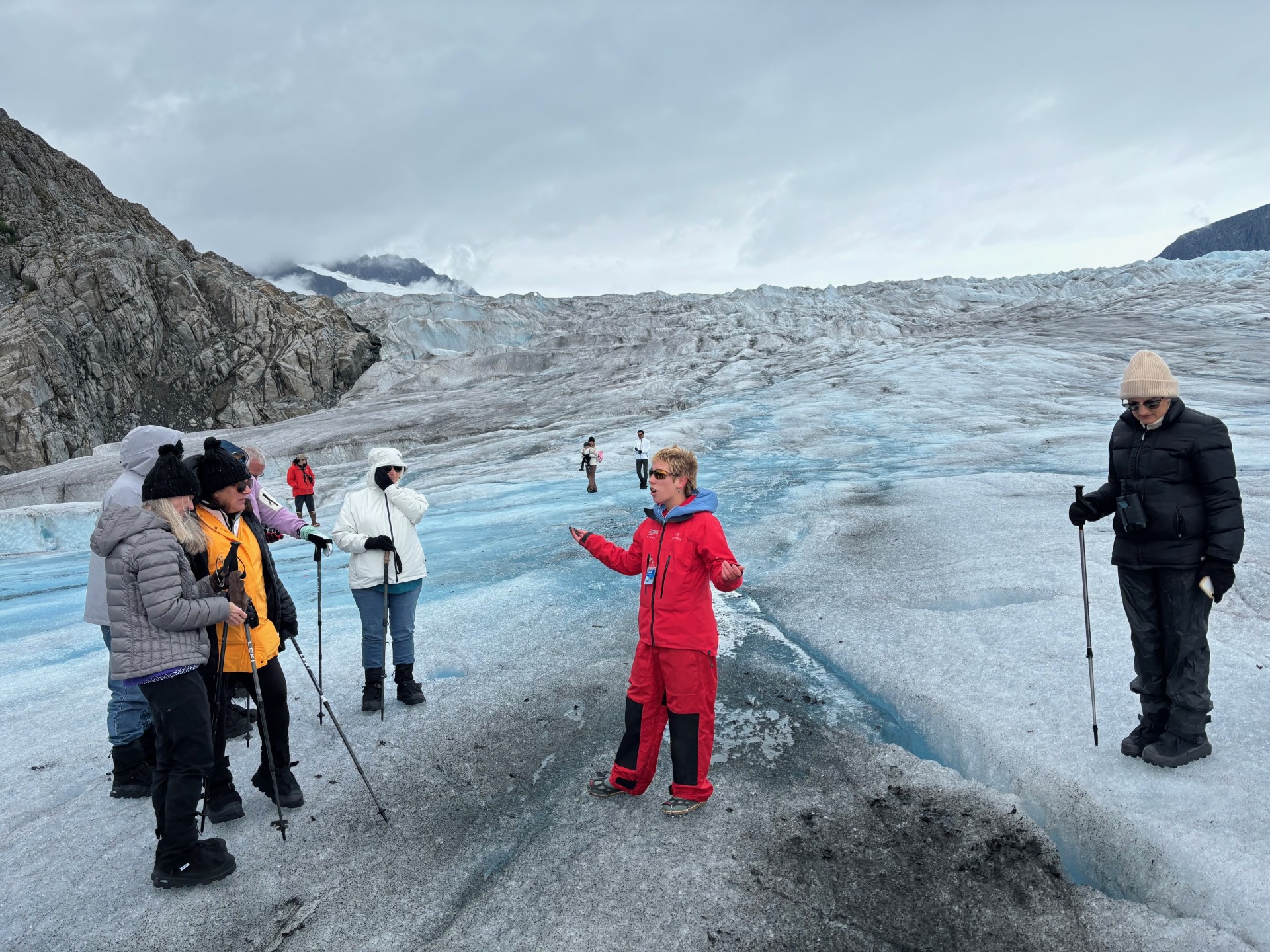 a group of people standing on top of a snow covered mountain