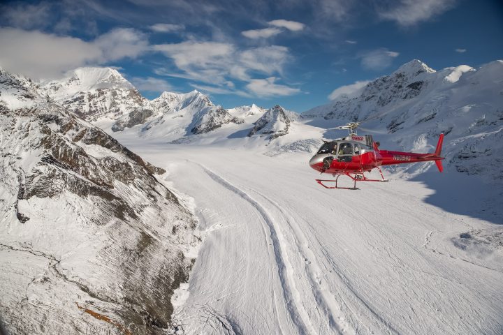 a man riding skis down a snow covered mountain