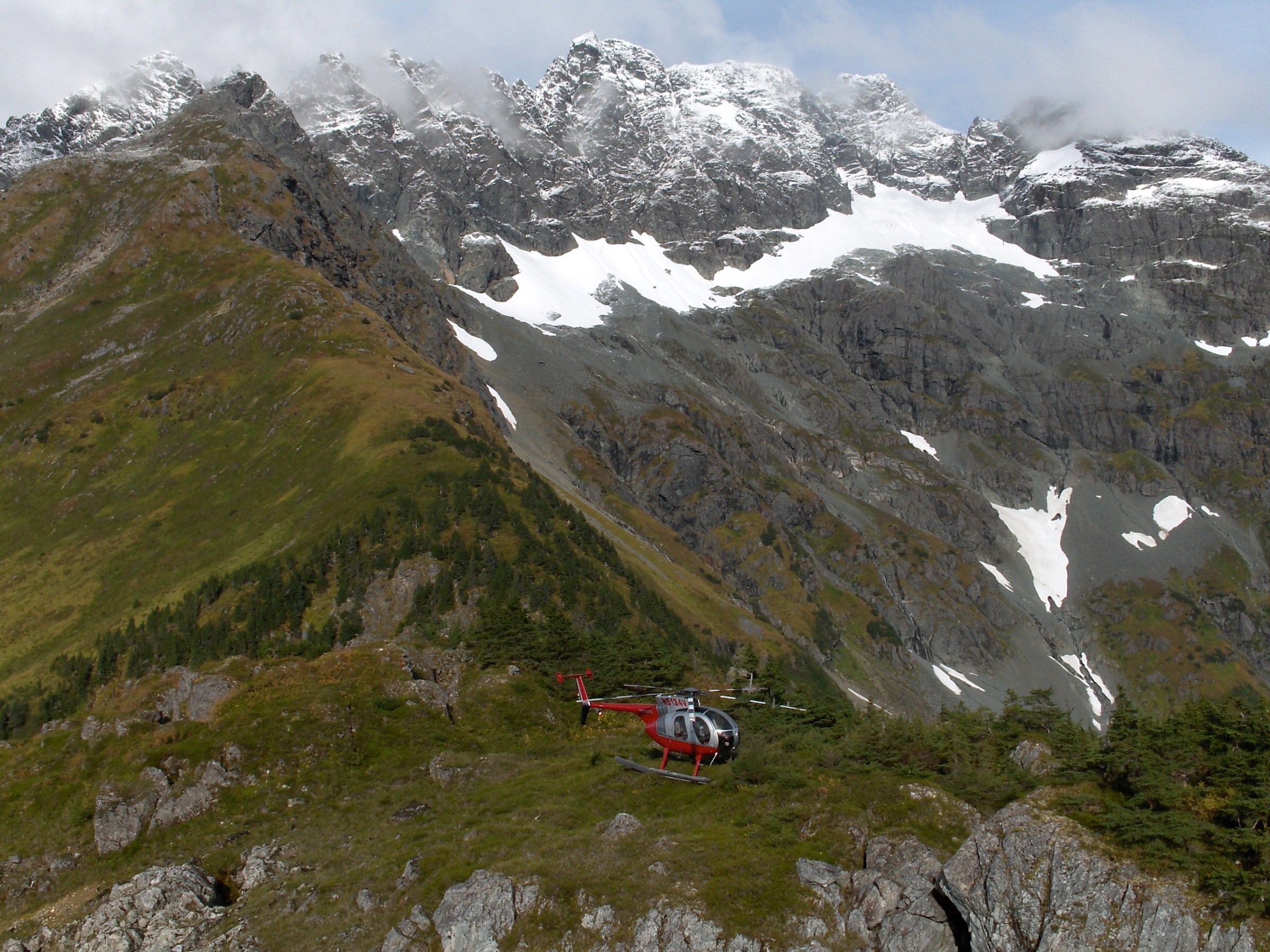 a group of people riding skis down a snow covered mountain