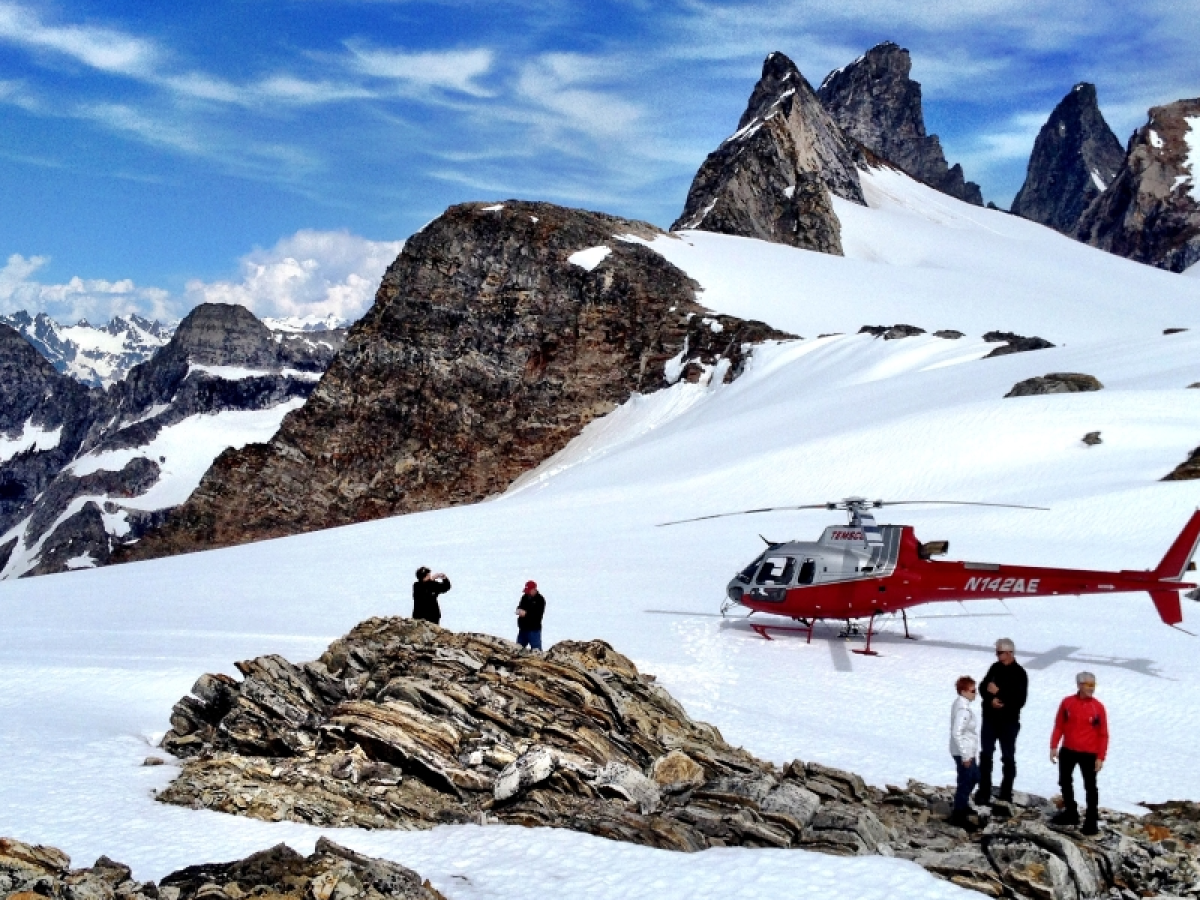 a man standing on top of a snow covered mountain