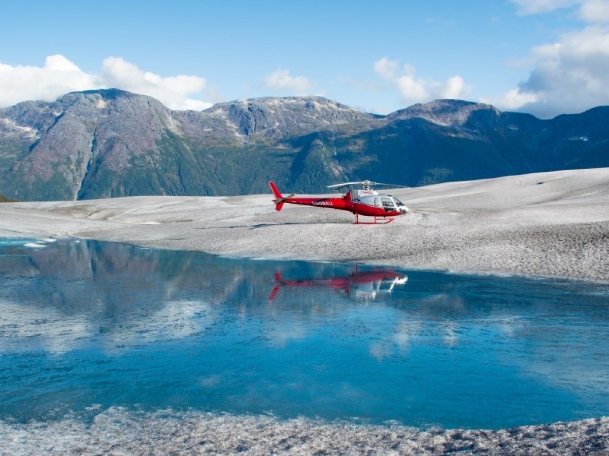 a small boat in a body of water with a mountain in the background